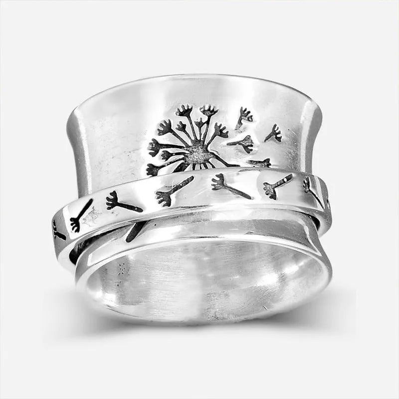 Silver coloured rotatable floral fashion ring on a hand, showing the spinning flower design.