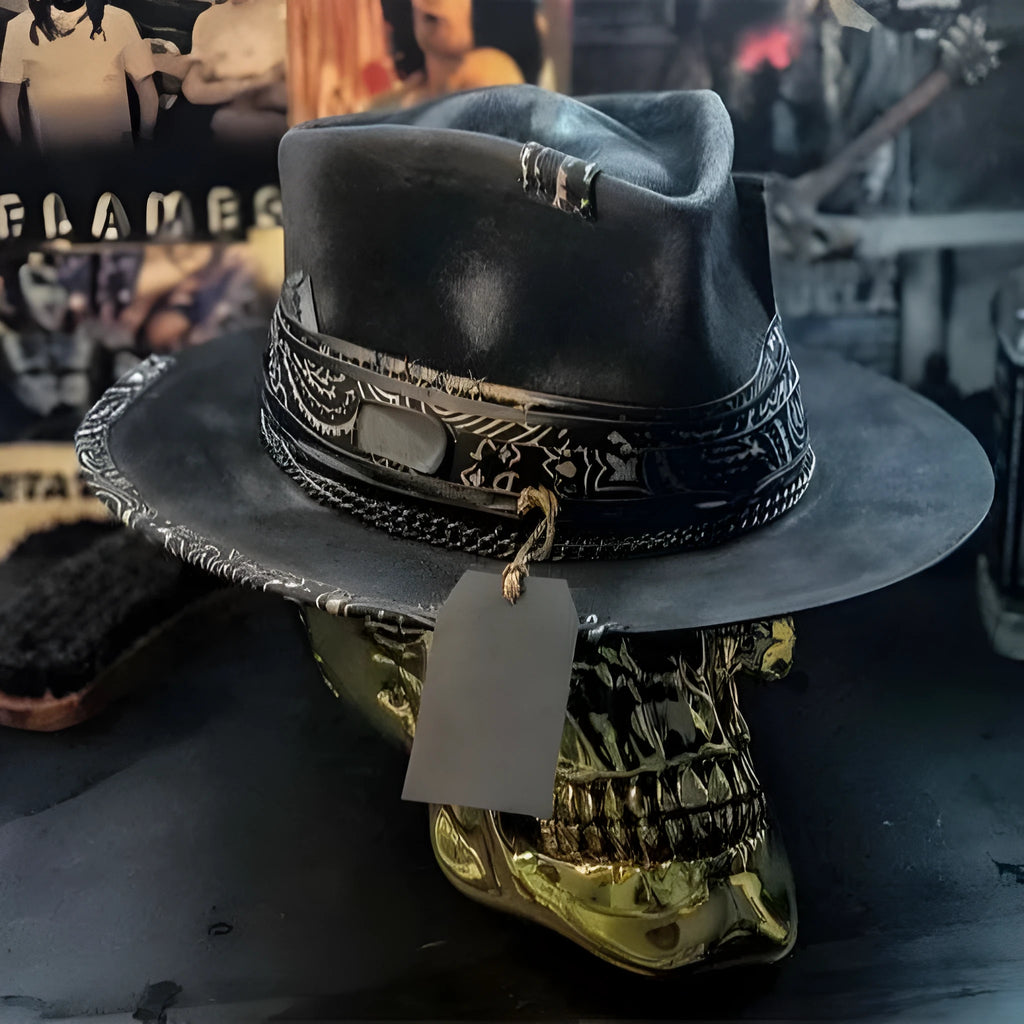 Handmade wool felt skull hat with a pointed conical crown on a neutral background