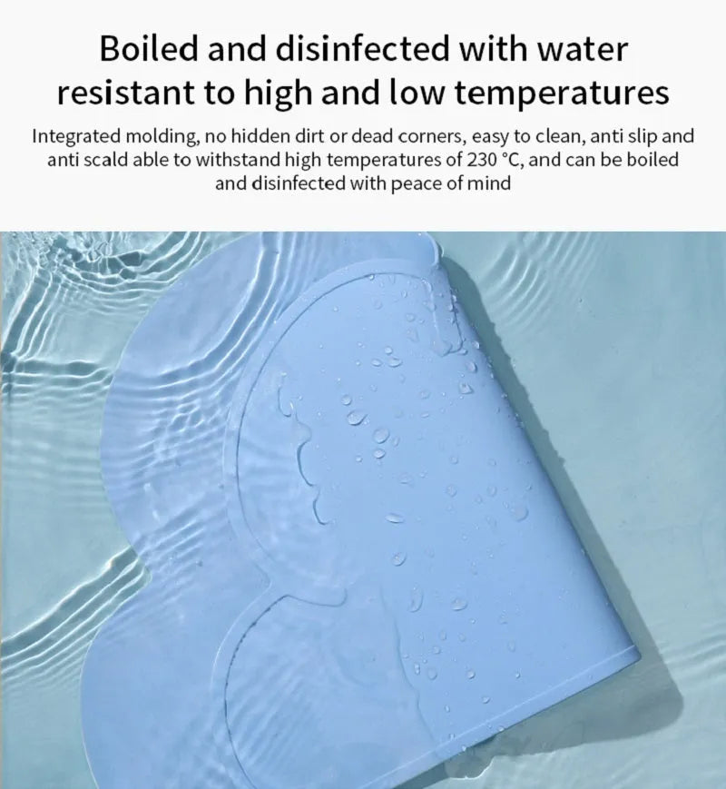 Blue waterproof silicone pet feeding mat for dog or cat bowls on a wooden floor.