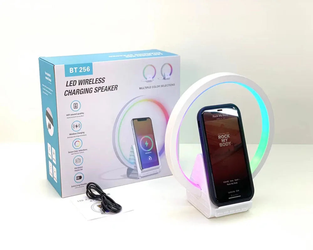 White smart Bluetooth speaker with 15W wireless charging surface and USB port on desktop