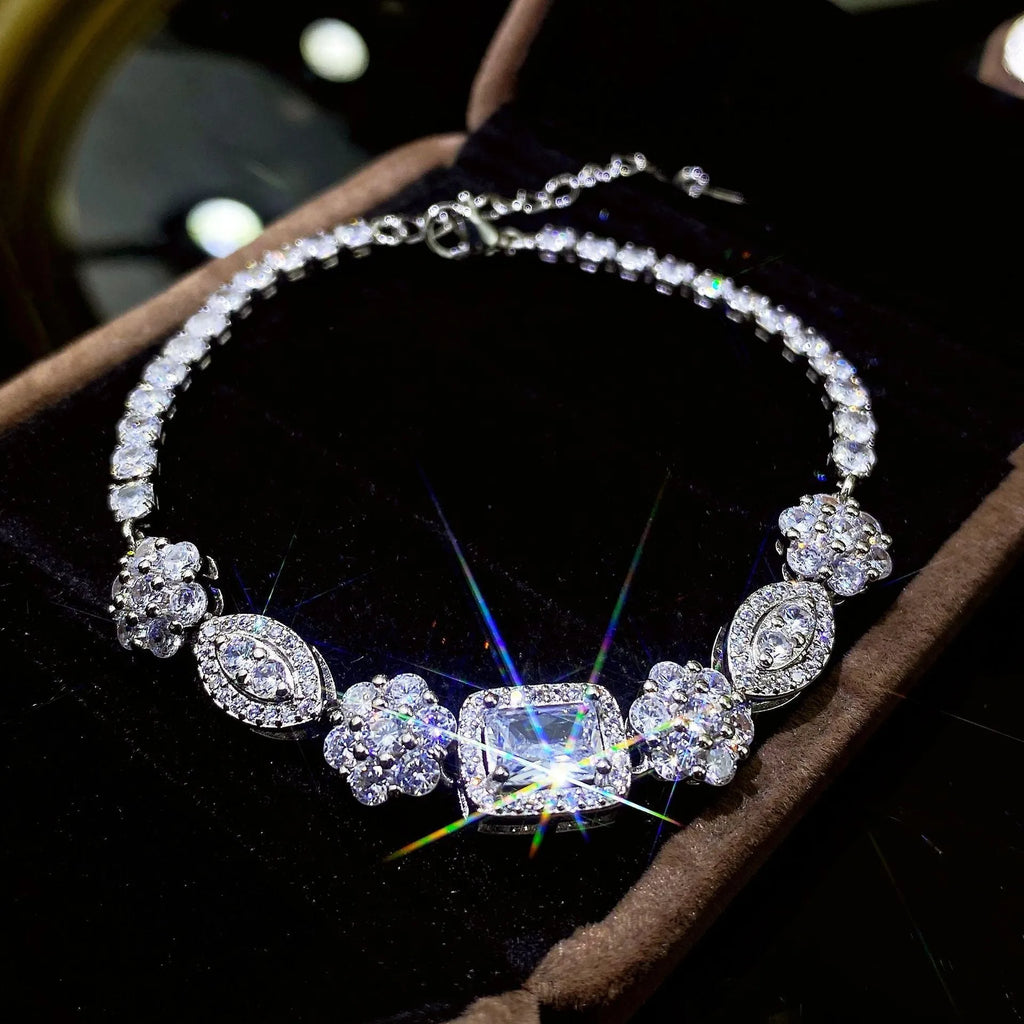 Women's sterling silver-plated bracelet with zircon stones on a geometry-patterned chain.