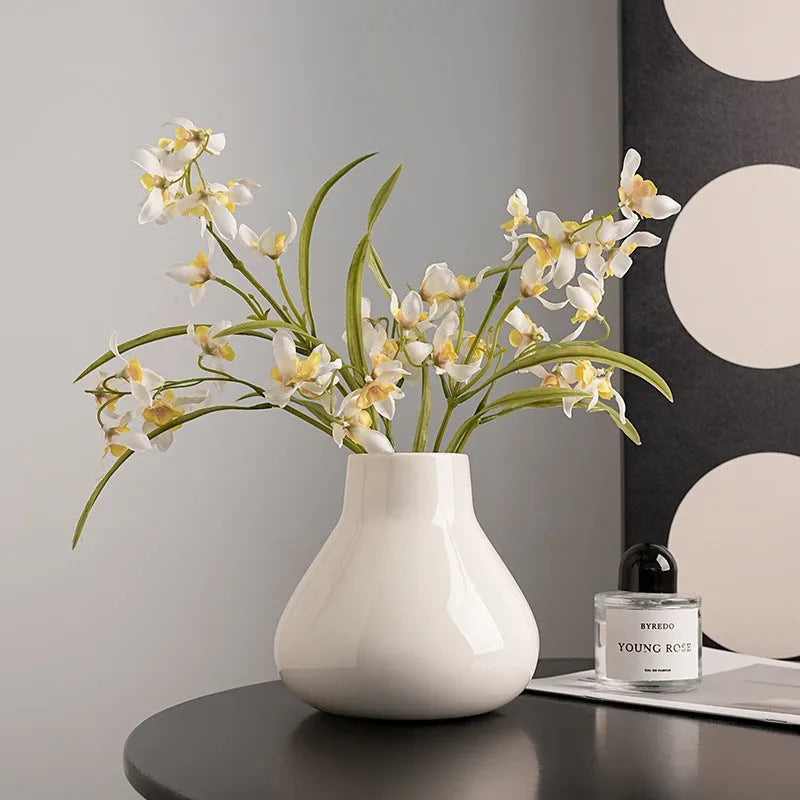 Ceramic round belly French style vase in black with two artificial white orchid flowers