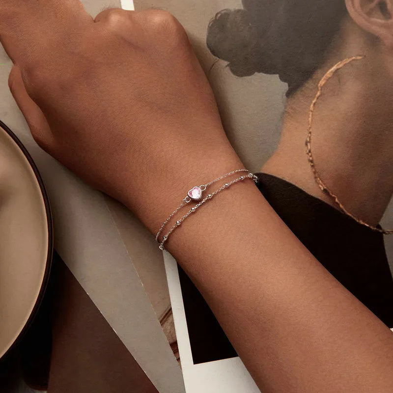 Women's sweet girlish style sterling silver bracelet with a small heart charm on an adjustable chain.