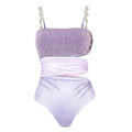 Purple hollow one-piece swimsuit with matching wrap skirt on a model.