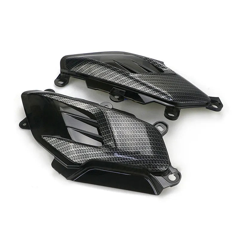 Pair of Yamaha NMAX LED side lamps with carbon fibre design on a blue background.