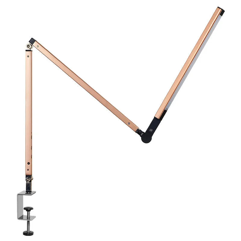 Black LED clip desk lamp with adjustable folding arm and remote control on a wooden desk.