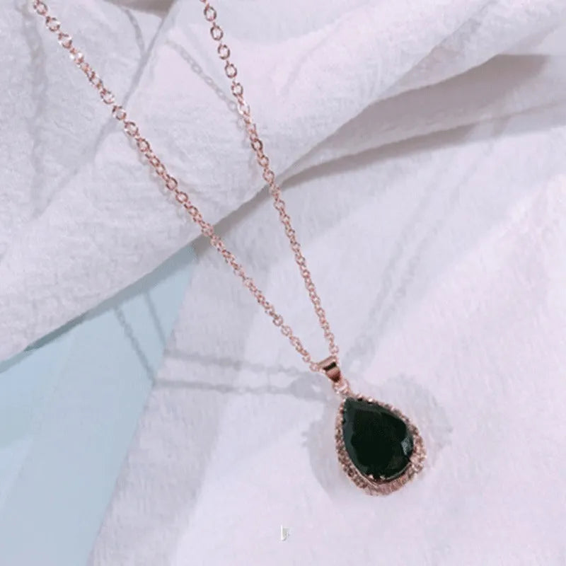 Women's alloy water drop necklace with rose gold electroplated colour and rhinestone inlays on a geometric pendant.