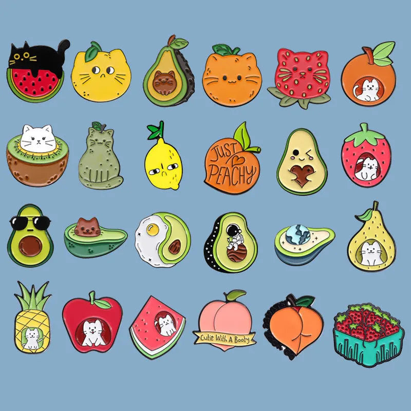 Colourful zinc alloy metal brooch with cartoon fruit and letter design on fabric.