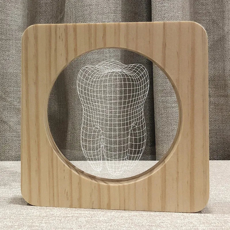 Wood colour tooth-shaped acrylic night light on a surface with USB cable.