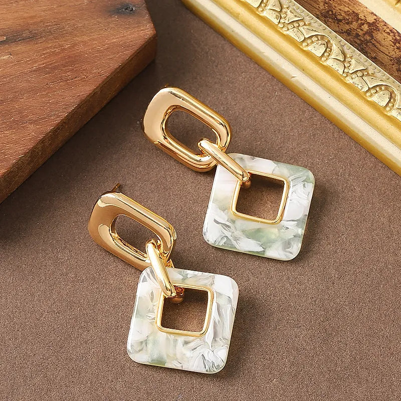 Geometric hollow square earrings with chamfered corners in electroplated copper