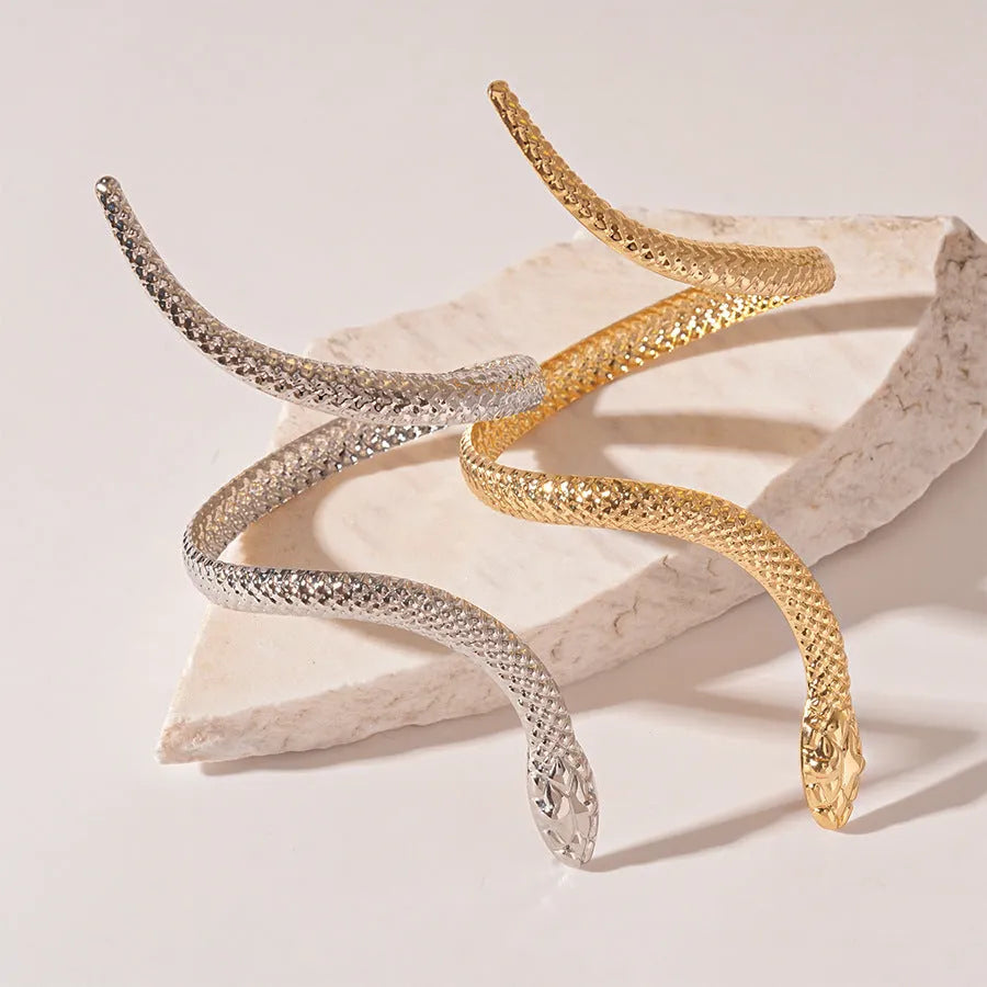 Snake-inspired ring and bracelet set with exaggerated twisted winding design in gold electroplated metal