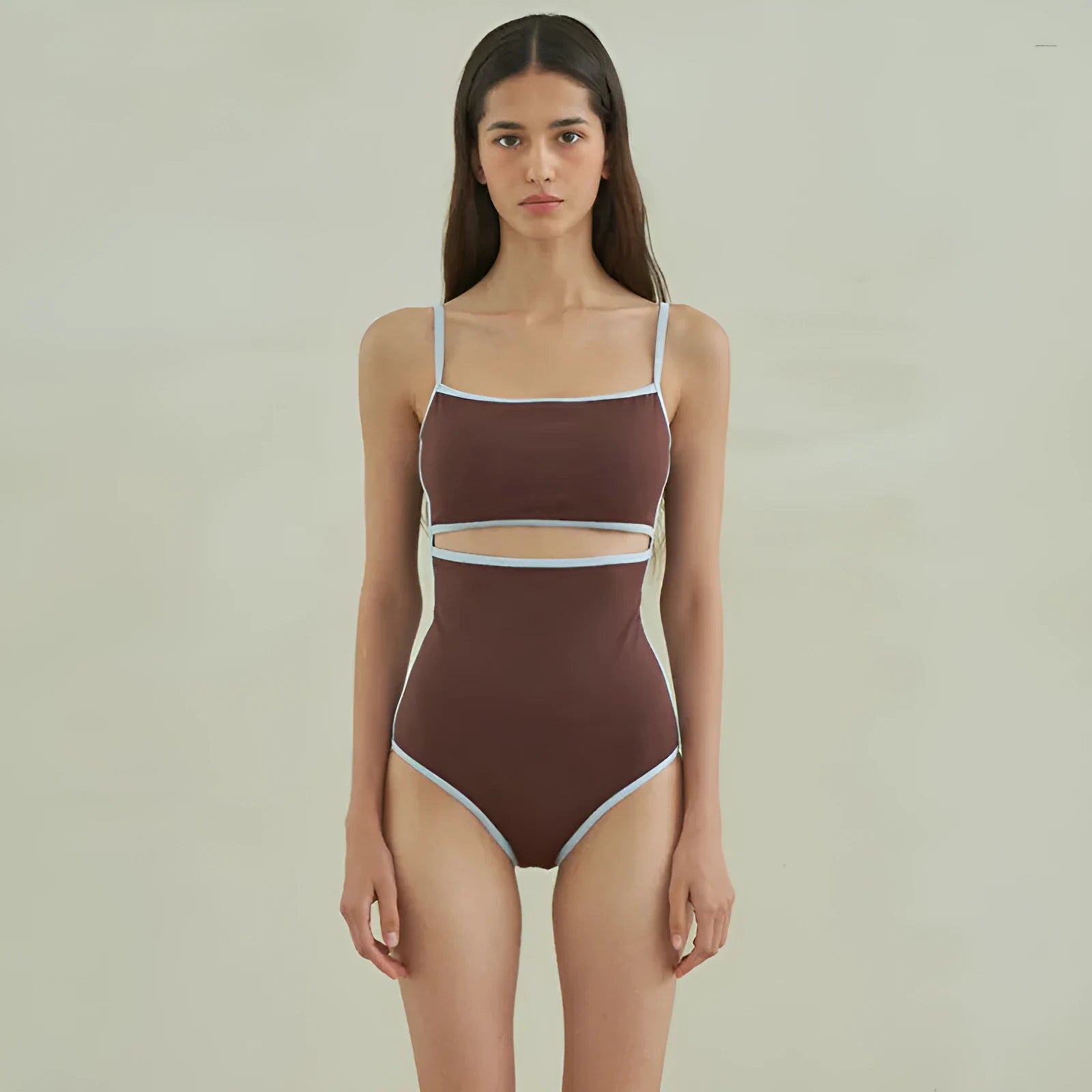 Brown triangle-style one-piece swimsuit for women on a hanger.