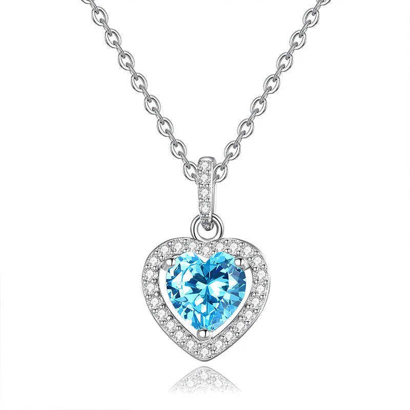 Women's sterling silver heart necklace with a round amethyst gemstone pendant on a cross chain.