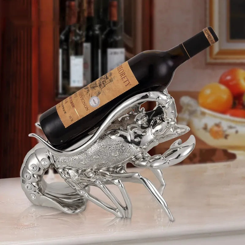 Lobster-shaped wine rack ornament in rose gold or silver resin finish on a table.