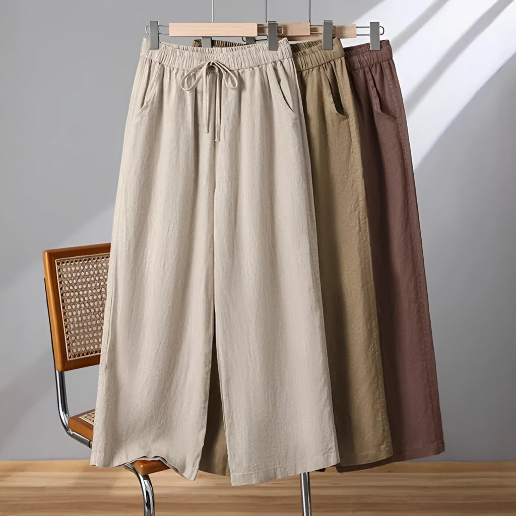 Women's straight-leg casual trousers in apricot colour with elastic waist and lace-up front detail.