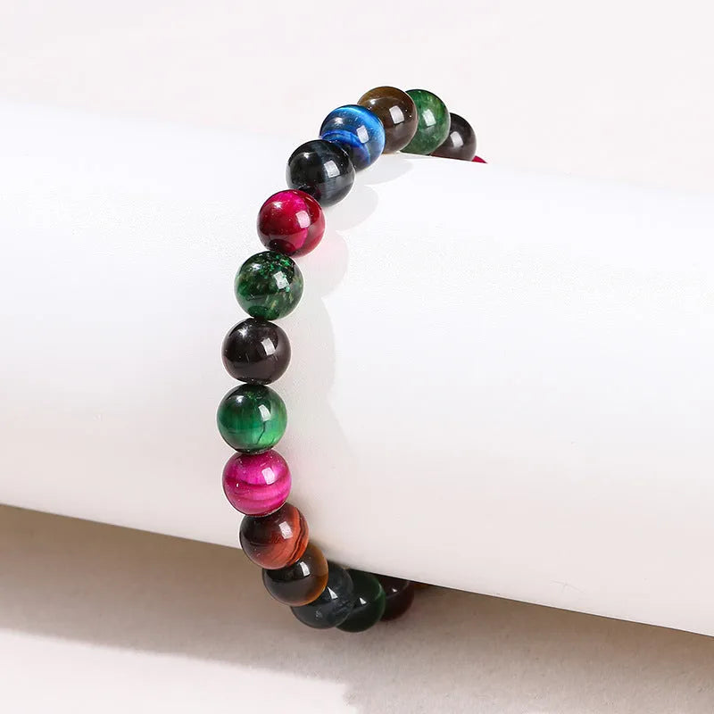 Colourful tiger eye bracelet with round beads in mixed sizes on a woman's wrist