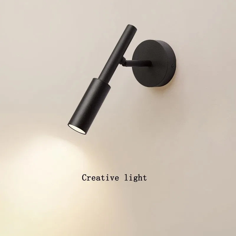 Modern wrought iron wall lamp in black with three colour light options for bedroom or living room
