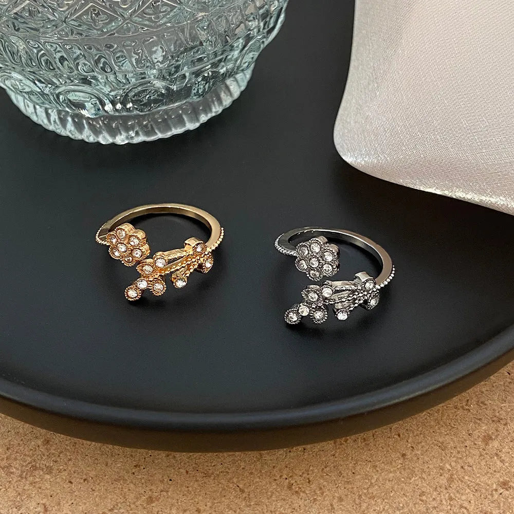 Women's open ring with diamond-cut floral leaf design in gold finish