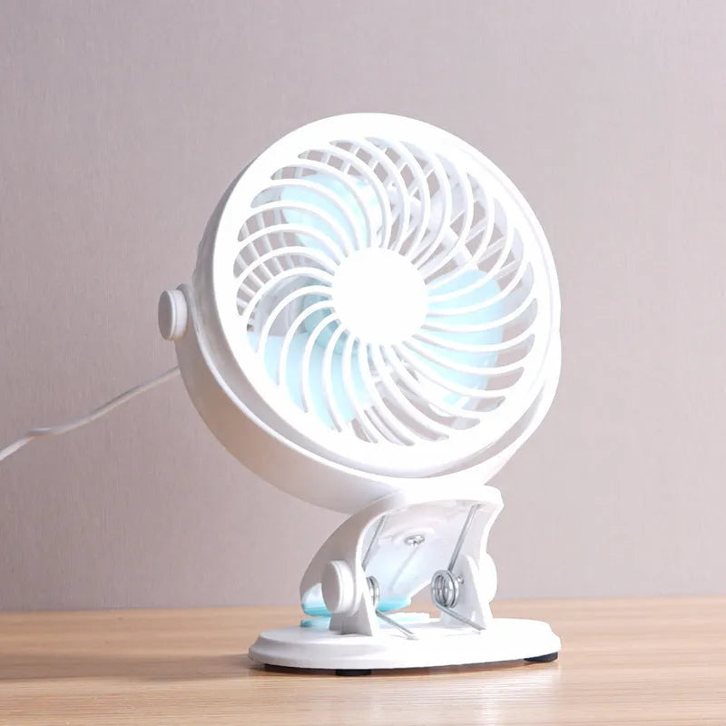 USB-powered mini clip fan with brushless motor and three blades on white desk