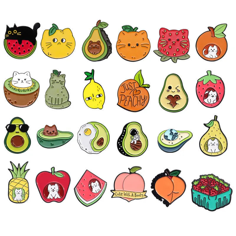 Colourful zinc alloy metal brooch with cartoon fruit and letter design on fabric.