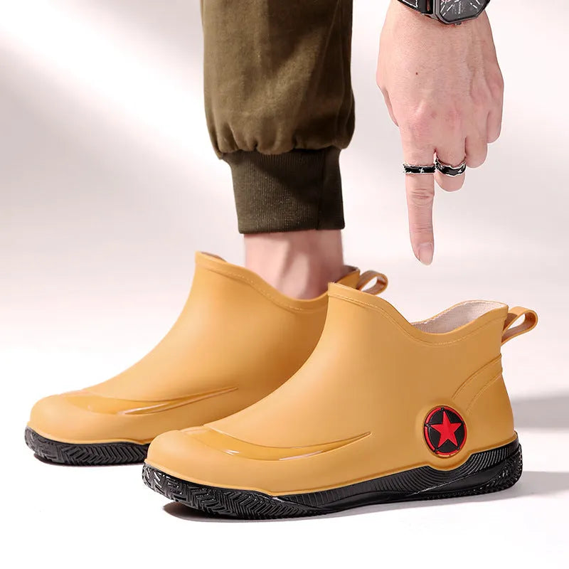 Unisex low-cut PVC rain boots in black with round toe and moulded plastic sole