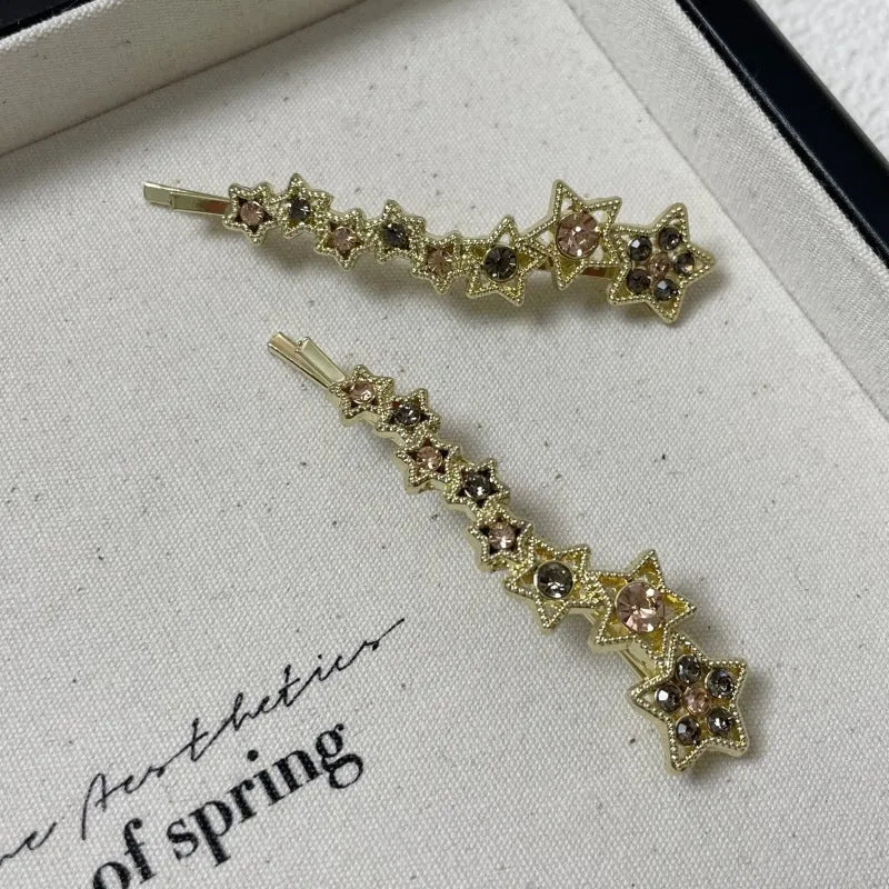 Gold electroplated alloy rhinestone barrette with star charm decoration