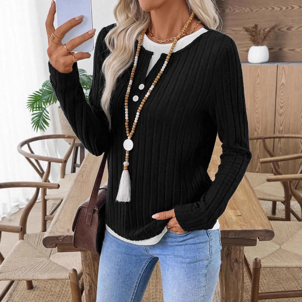 Women's black fake two-piece pullover sweater with round neck and button detail on concave stripe fabric