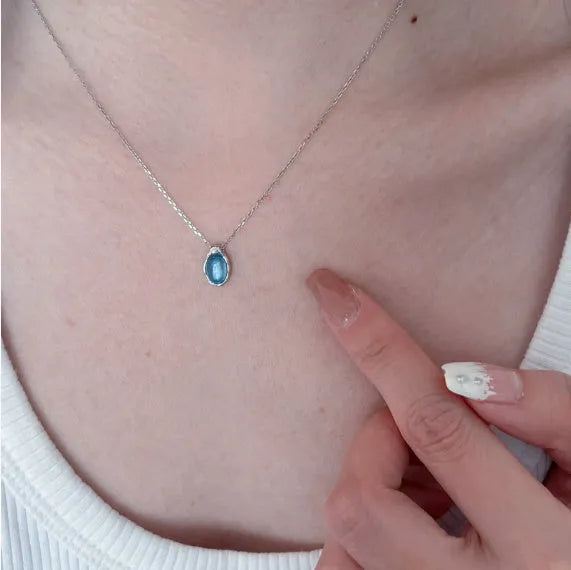 Navy blue water drop geometric pendant necklace with cross chain design on white background