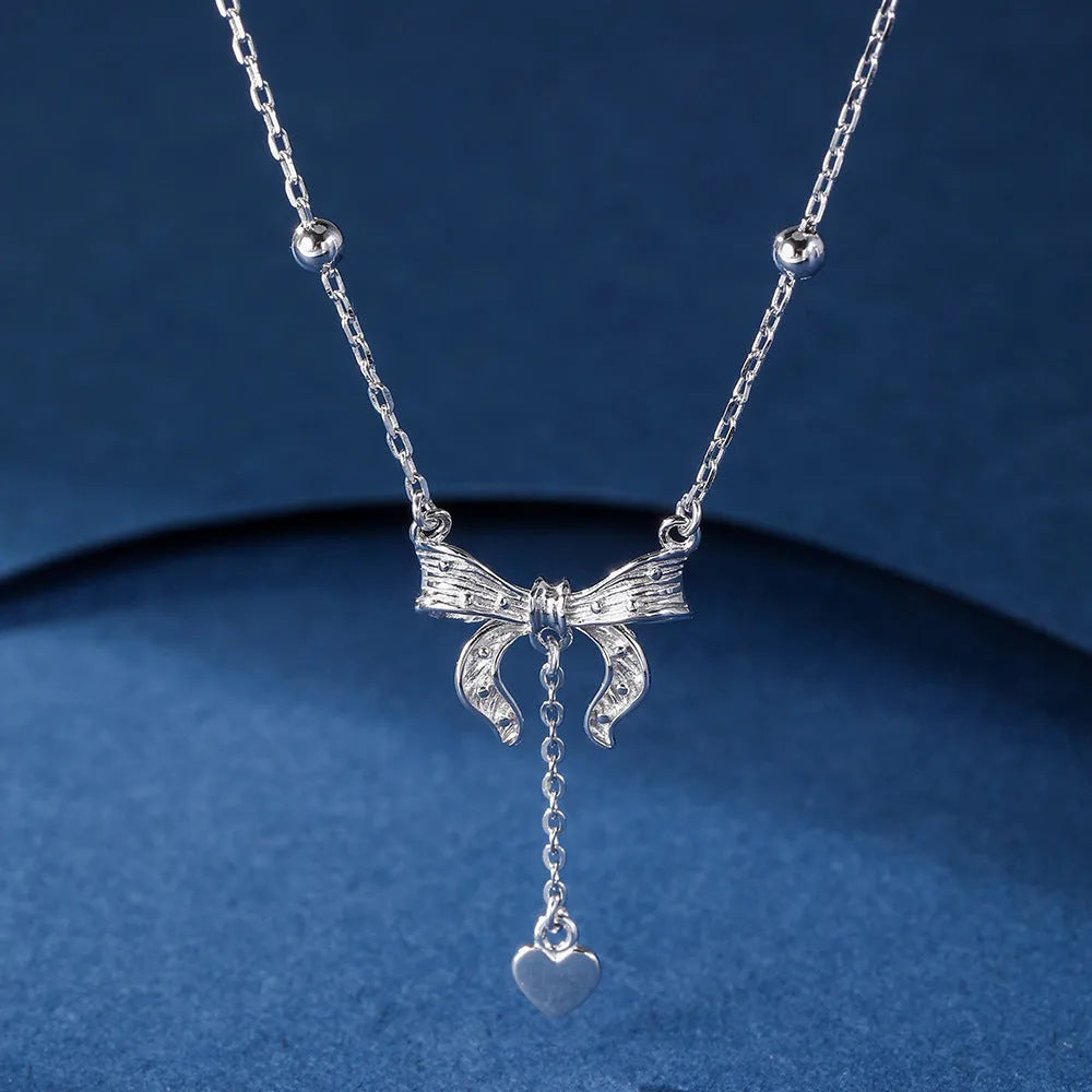S925 silver necklace with heart-shaped pendant featuring butterfly and bow design on adjustable O-ring chain
