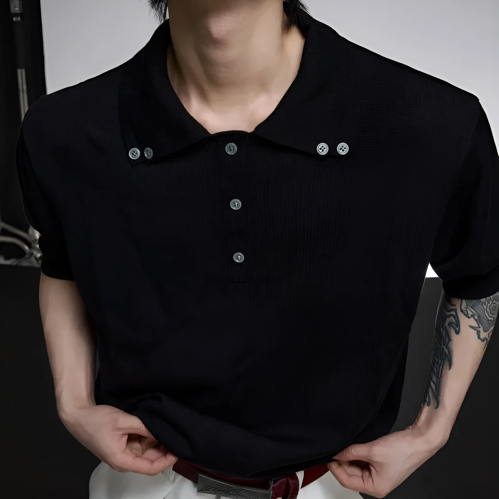 Man modelling a grey loose-fit polyester short-sleeve shirt with a double lapel collar design