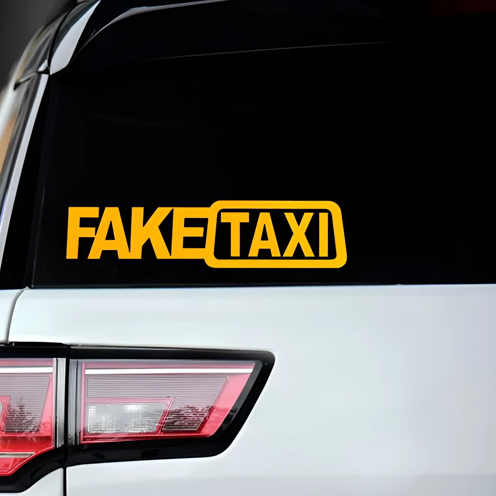 Waterproof FAKE TAXI car warning sticker in yellow, 20cm by 8cm, on a vehicle window.