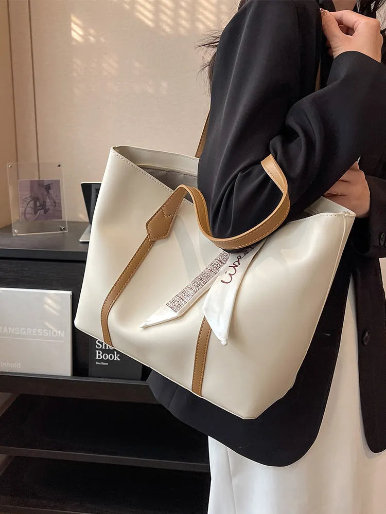 Soft women's crossbody tote bag in bucket silhouette showing sandwich pocket detail and shoulder strap