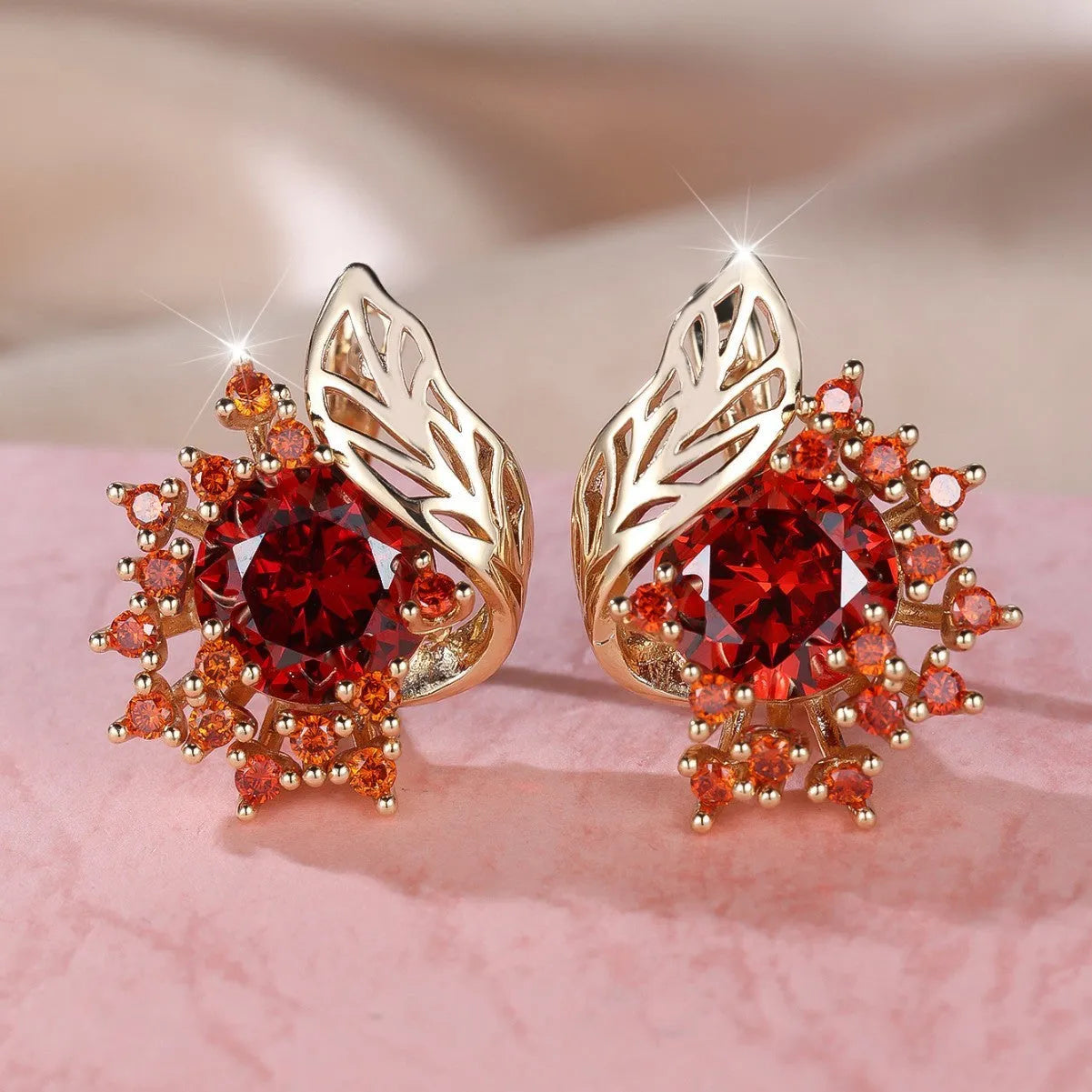 Rose gold coloured feather and flower design earrings with a choice of coloured zircon centre stones.