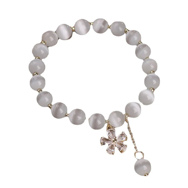 Women's white cat's eye crystal bracelet with flower tassel charm and safety buckle pendant clasp
