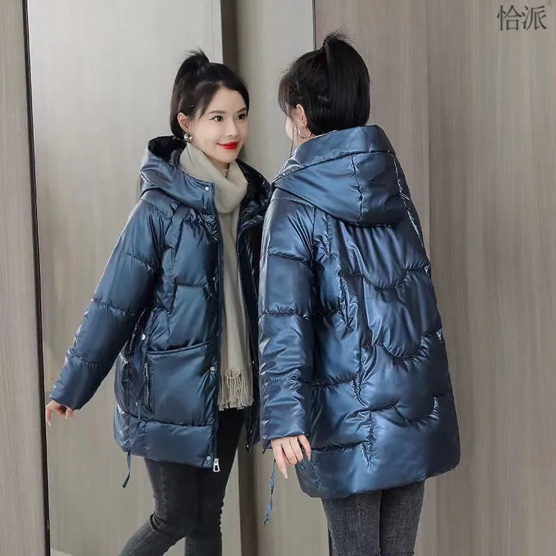Women's loose thick hooded winter jacket in green colour shown on a model.