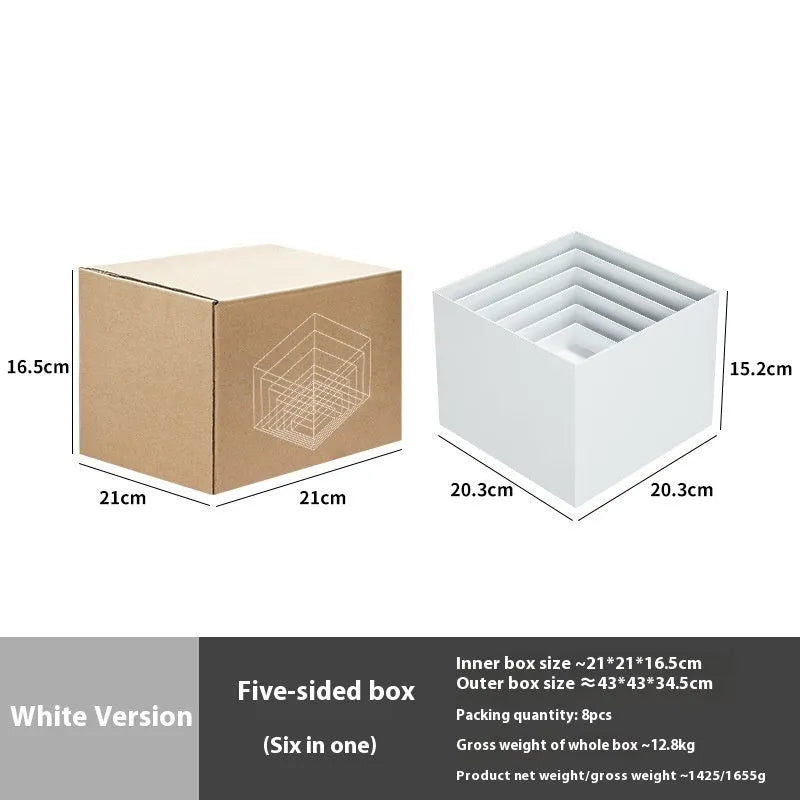 Set of six white plastic cube dessert display stands arranged on a table.