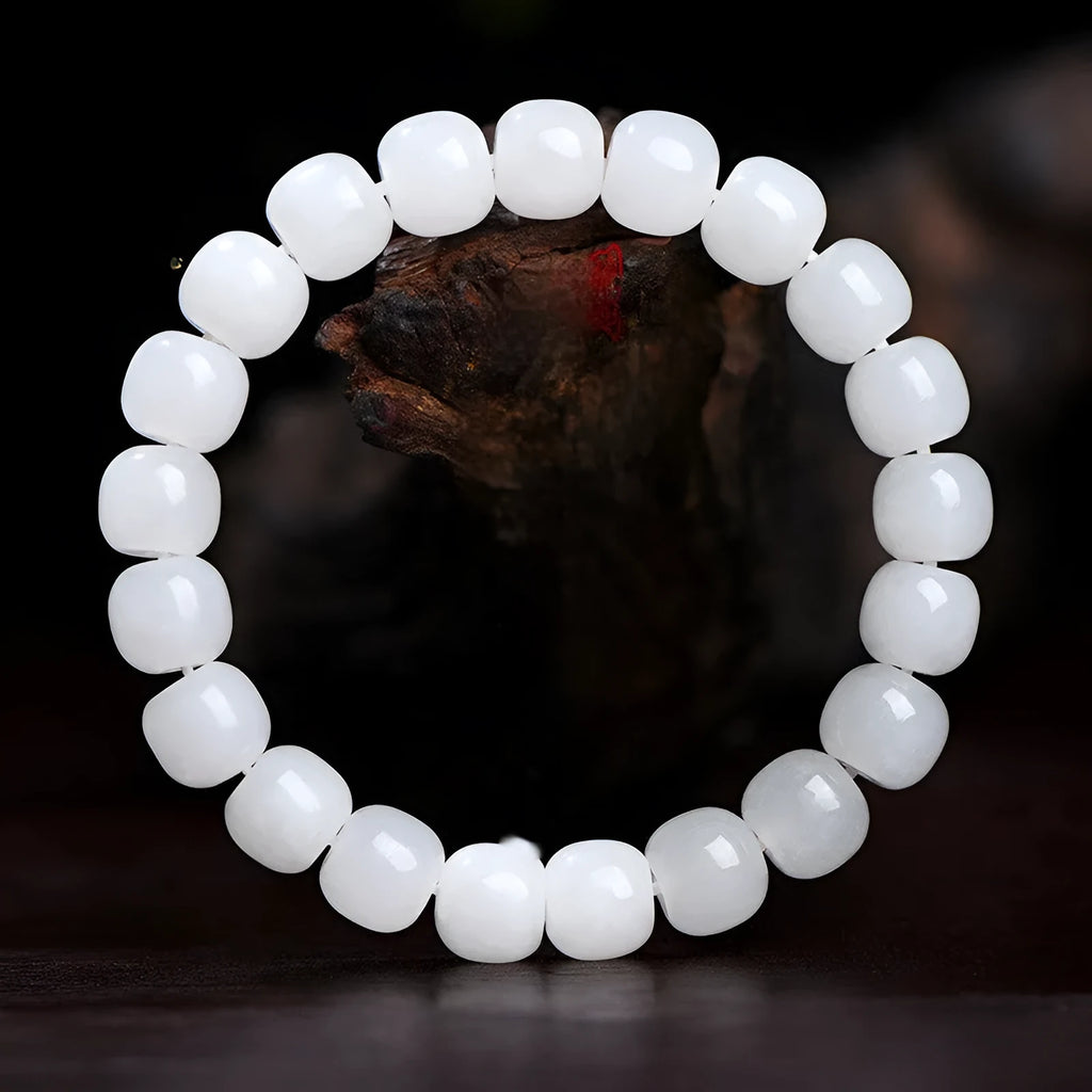 White Hetian jade barrel bead bracelet showing three bead size options on wrist