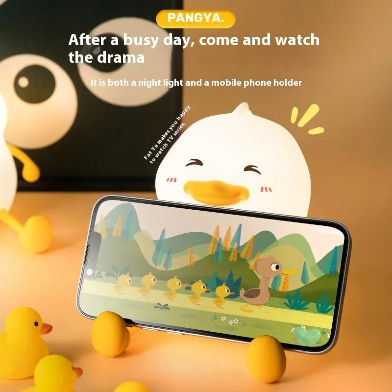 Chubby silicone night light with phone holder slot, showing touch controls and soft LED glow