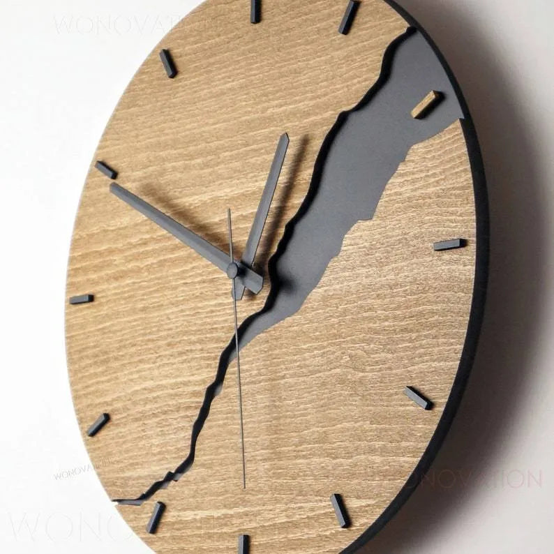 Modern round wooden wall clock with crackle design, white face, and black hands.