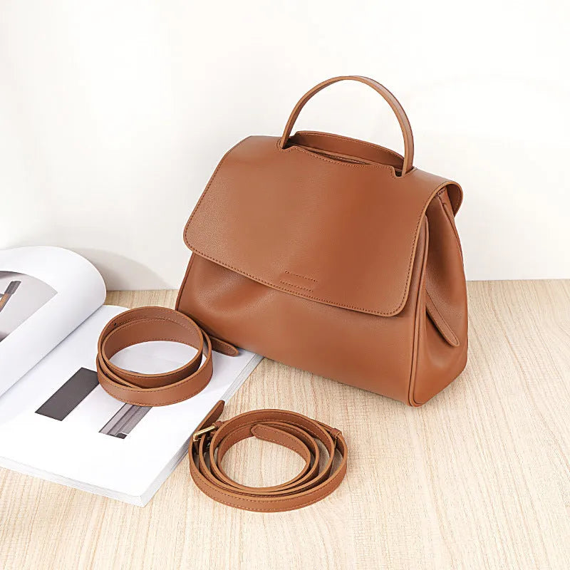 Soft genuine leather women's shoulder messenger bag in horizontal square shape with sewing thread detail, black colour