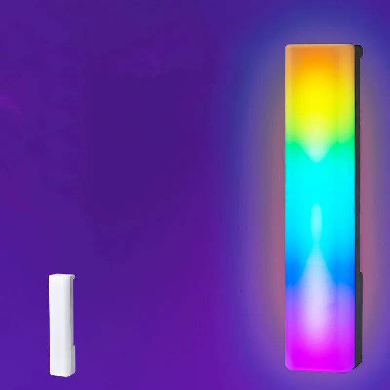 Black and white 3D RGB voice-activated music rhythm ambiance lamp on a table.