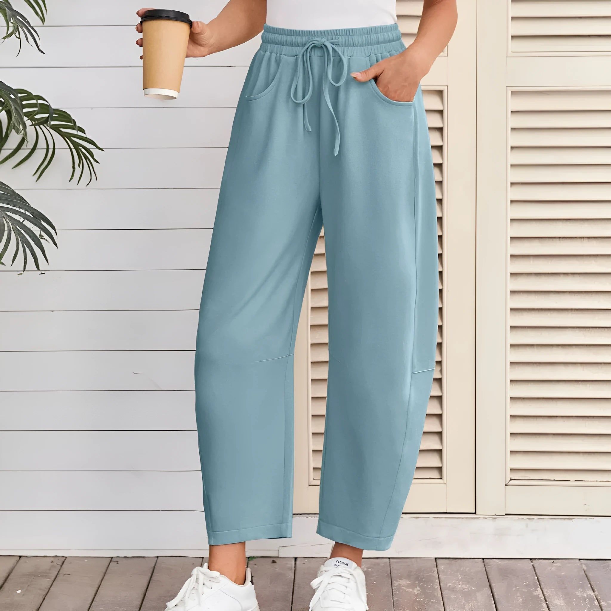 Women's loose cotton cropped sweatpants with drawstring waist in street fashion styling