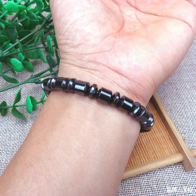 Black pentagram magnetic therapy bracelet with magnetite and hematite beads on wrist