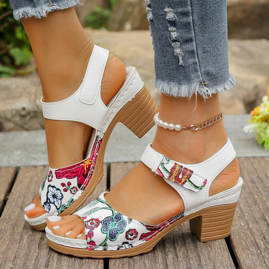 White women's high heel sandals with adjustable Velcro buckle strap on a rubber sole.