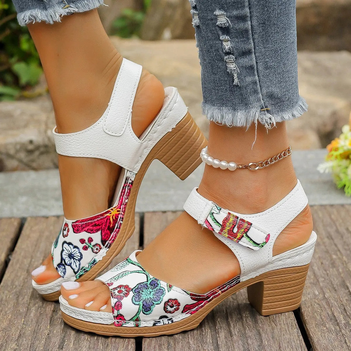 White women's high heel sandals with adjustable Velcro buckle strap on a rubber sole.