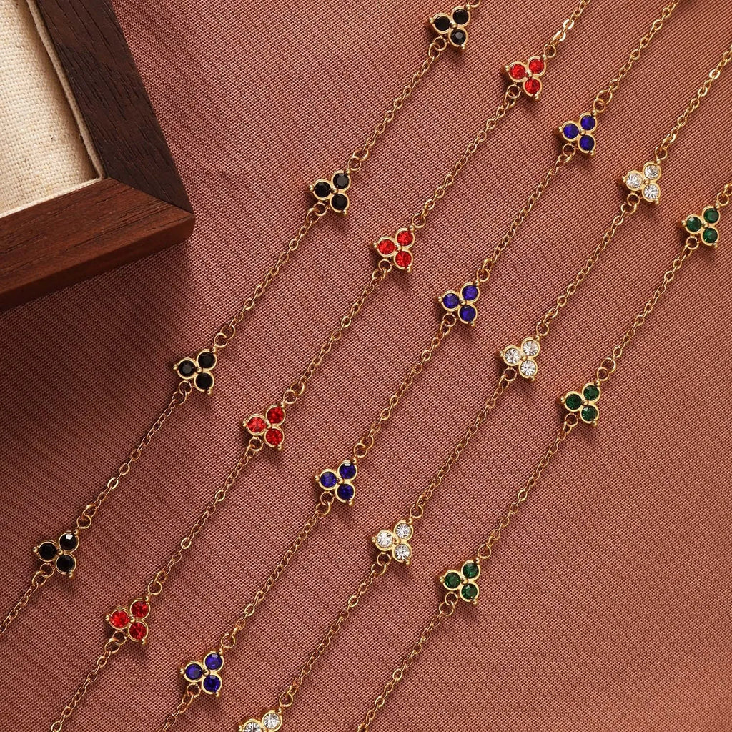 Women's geometric stainless steel bracelet with triangular diamond elements in gold or steel finish with coloured stones.