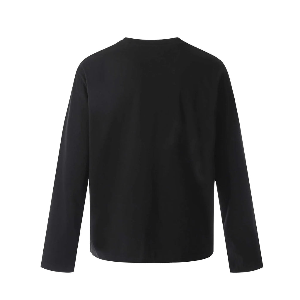 Man modelling a simple black loose-fit long sleeve cotton pullover shirt.
