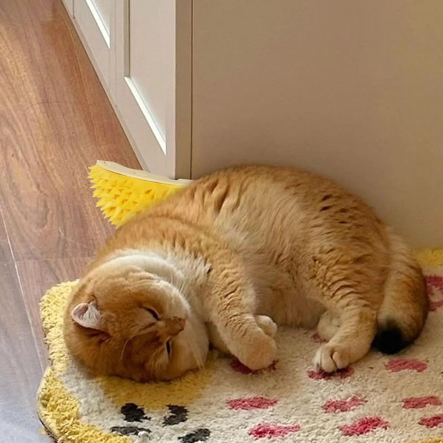 Yellow durian-shaped cat corner scratcher with spiky texture mounted on a wall