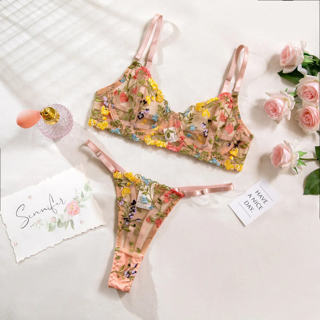 Women's floral design bikini underwear suit shown in multiple colours including skin, purple, and black.