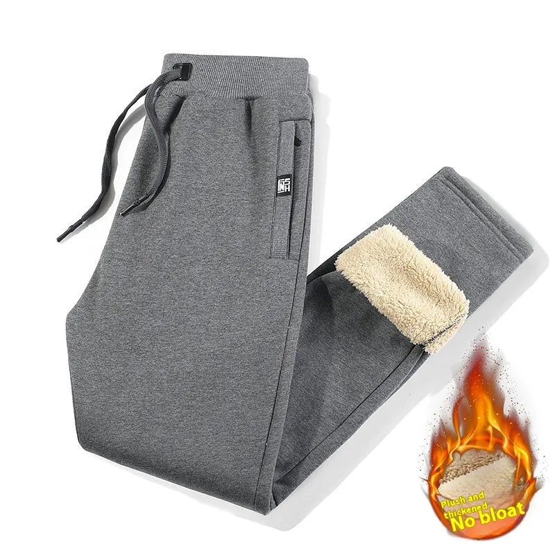 Men's grey fleece-lined oversized track pants with elastic waistband and straight leg cut